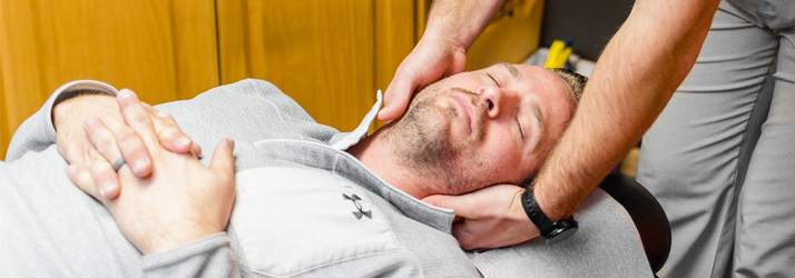 Chiropractor Algona IA Dalton Frick Adjusting A Patient