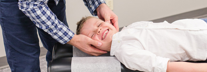 Chiropractor Algona IA Shane Taffe Adjusting A Child Patient
