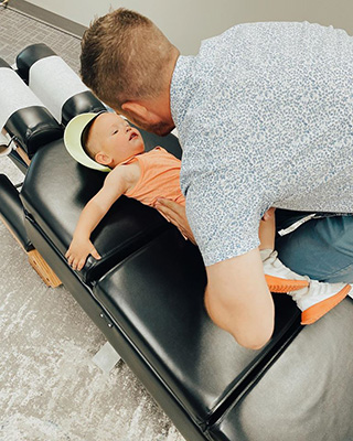 Chiropractor Algona IA Shane Taffe Adjusting Child On Table
