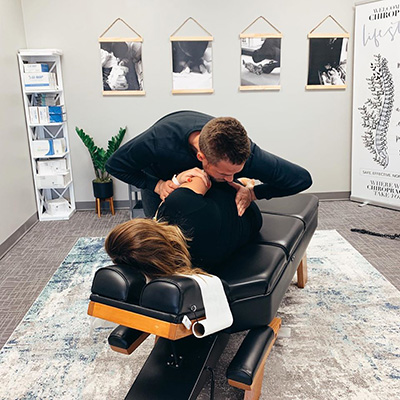 Chiropractor Algona IA Shane Taffe Adjusting Patient In Room