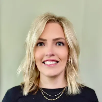 Jess Chiropractic Assistant blonde hair smiling at the camera